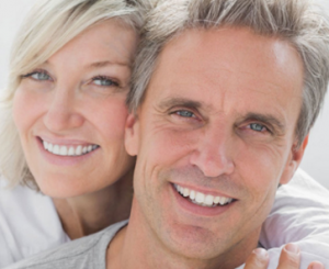 Smiling Couple With Dental Implants Improve Your Smile 