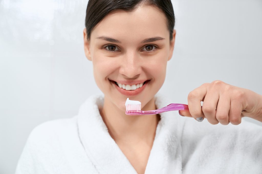 girl about to brush her teeth as part of her composite bonding aftercare